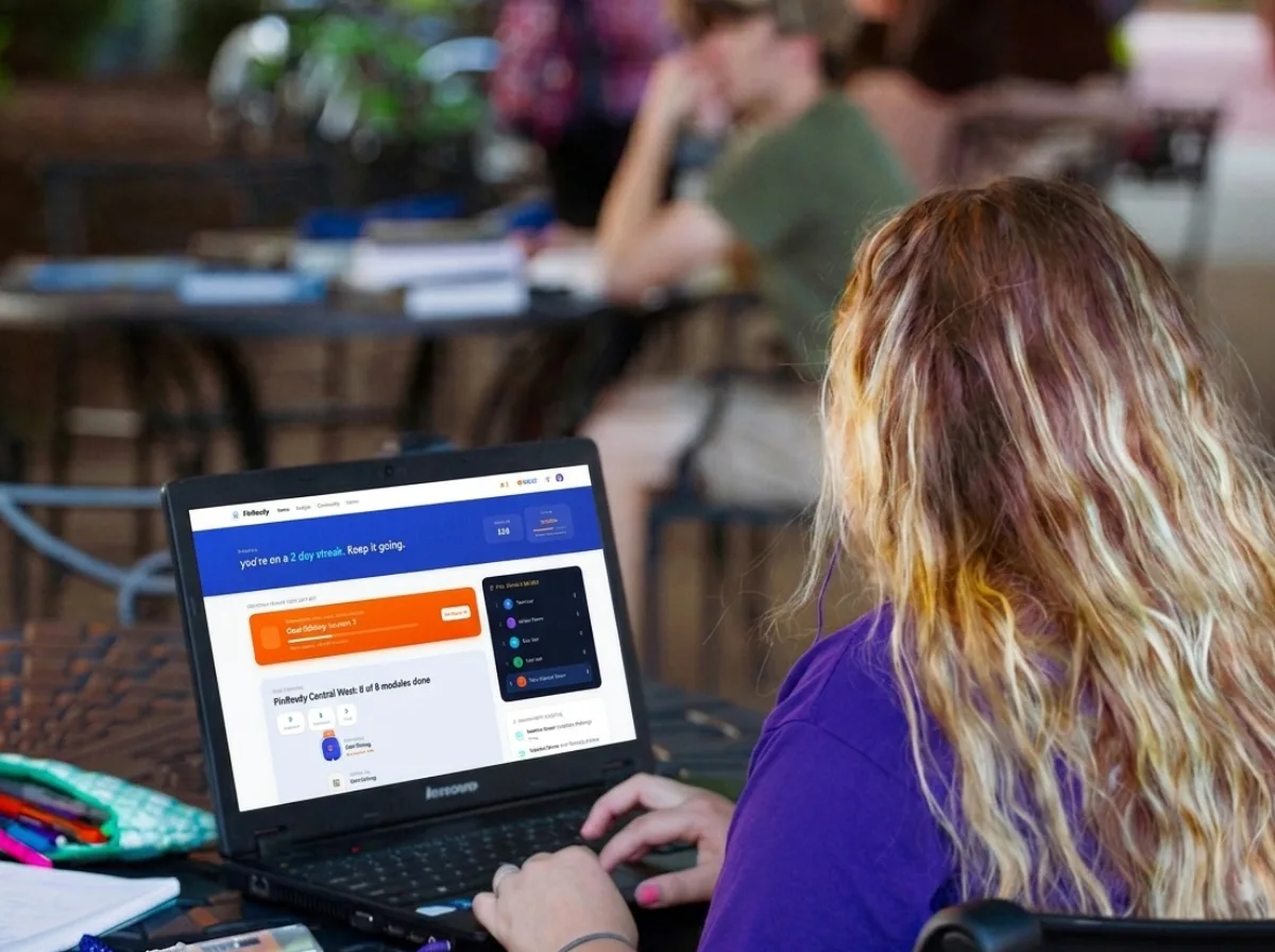 A student viewing their FinReady course dashboard on a laptop